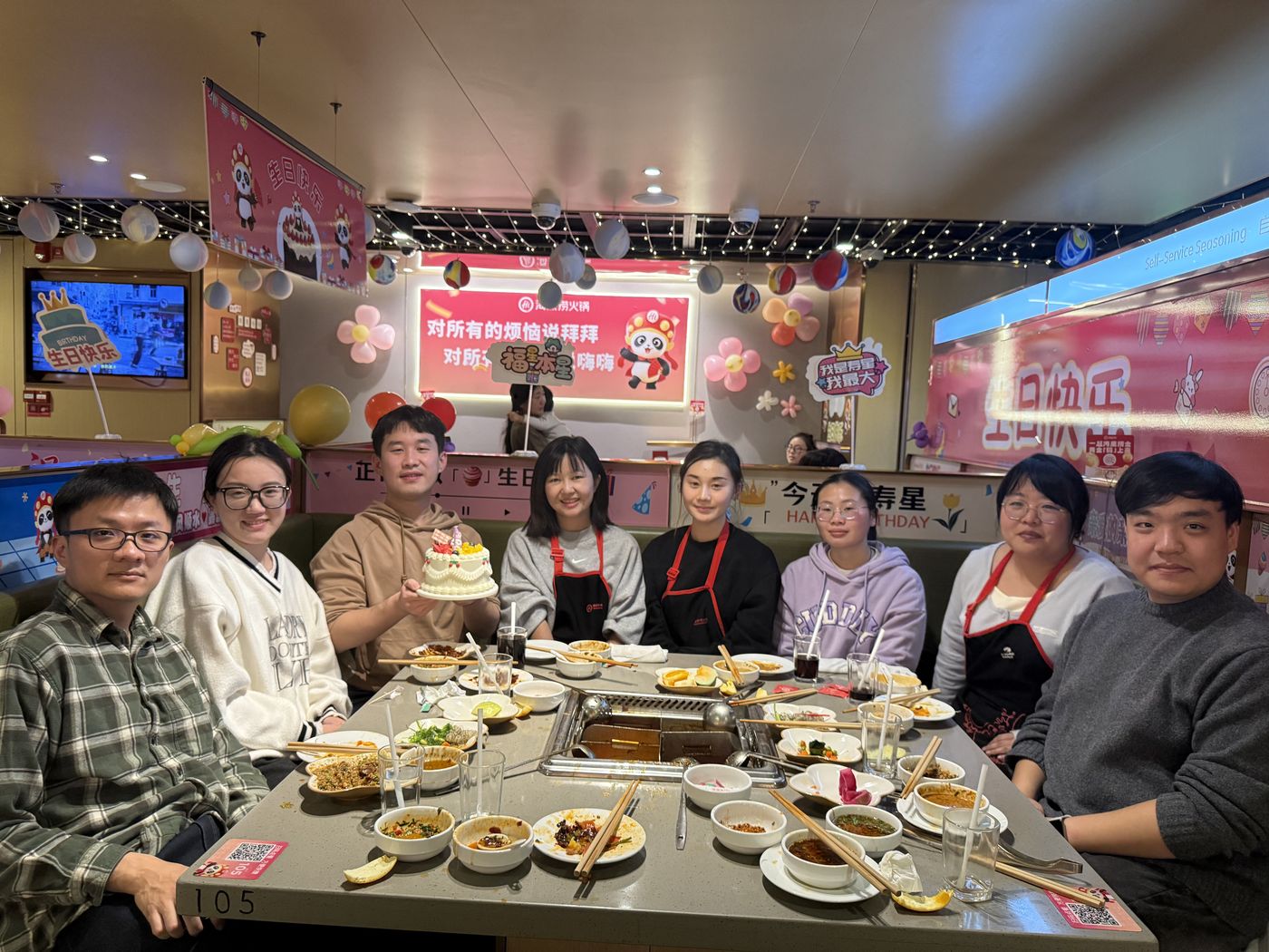 The lab around a hotpot table with a birthday cake